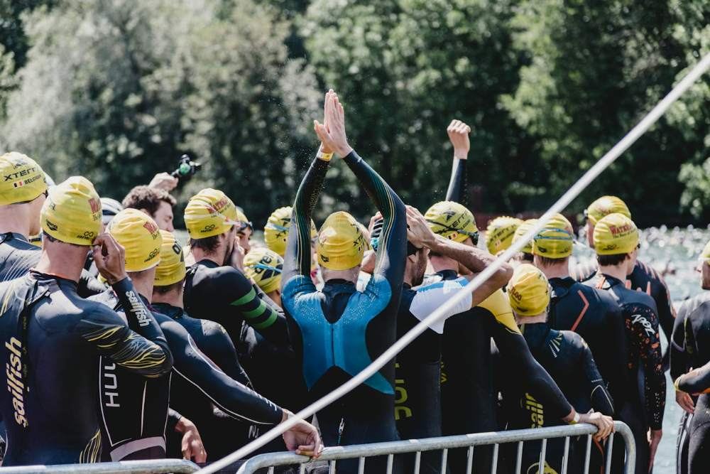 Triathletes in wetsuits before the swim start